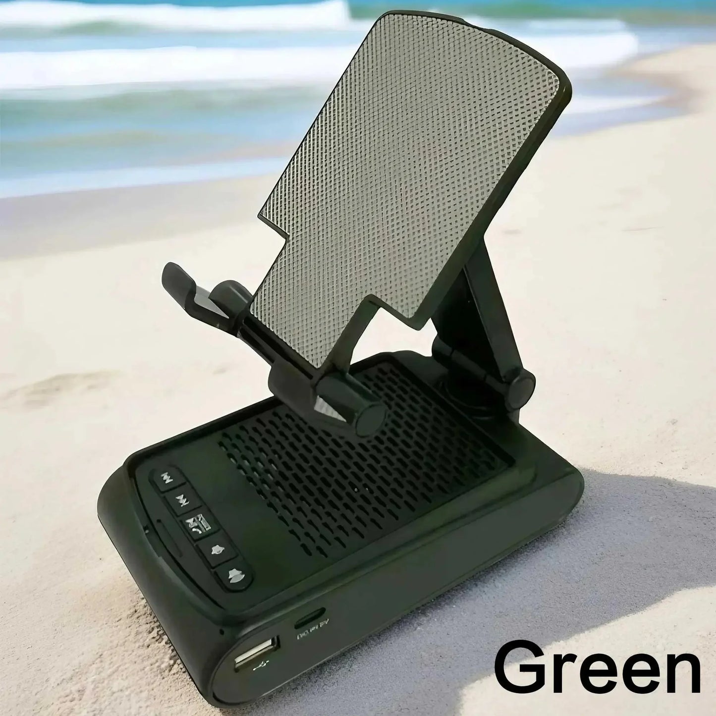 Green portable adjustable phone holder with speaker and USB port on sandy beach