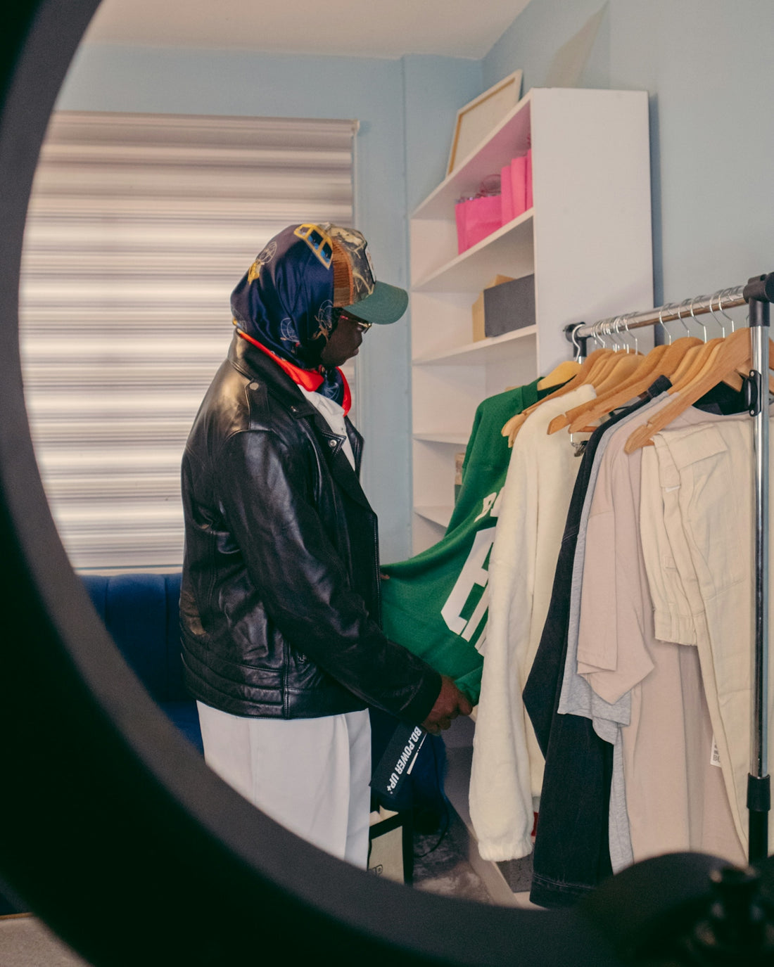 a man standing in front of a rack of clothes