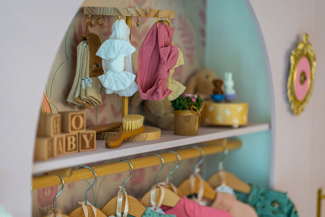 Doll clothes and accessories on a shelf and rack