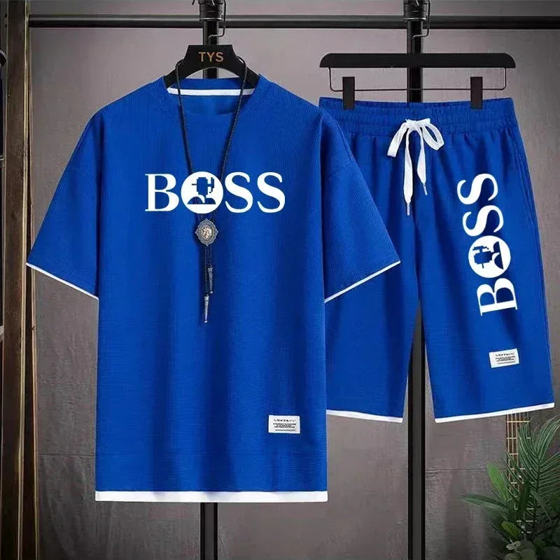 Blue casual two-piece outfit with BOSS text and puzzle piece logo, featuring t-shirt and shorts