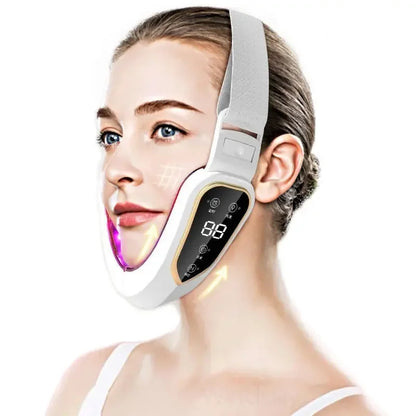 Woman wearing a white smart facial slimming strap with digital control panel and LED light on chin