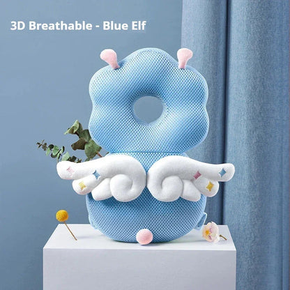 Blue elf-shaped 3D breathable baby pillow with white wings and pink antennae on white pedestal