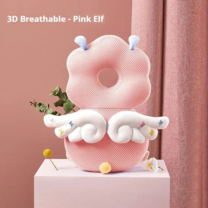 3D breathable pink elf baby pillow with white wings and antennae on pink backdrop