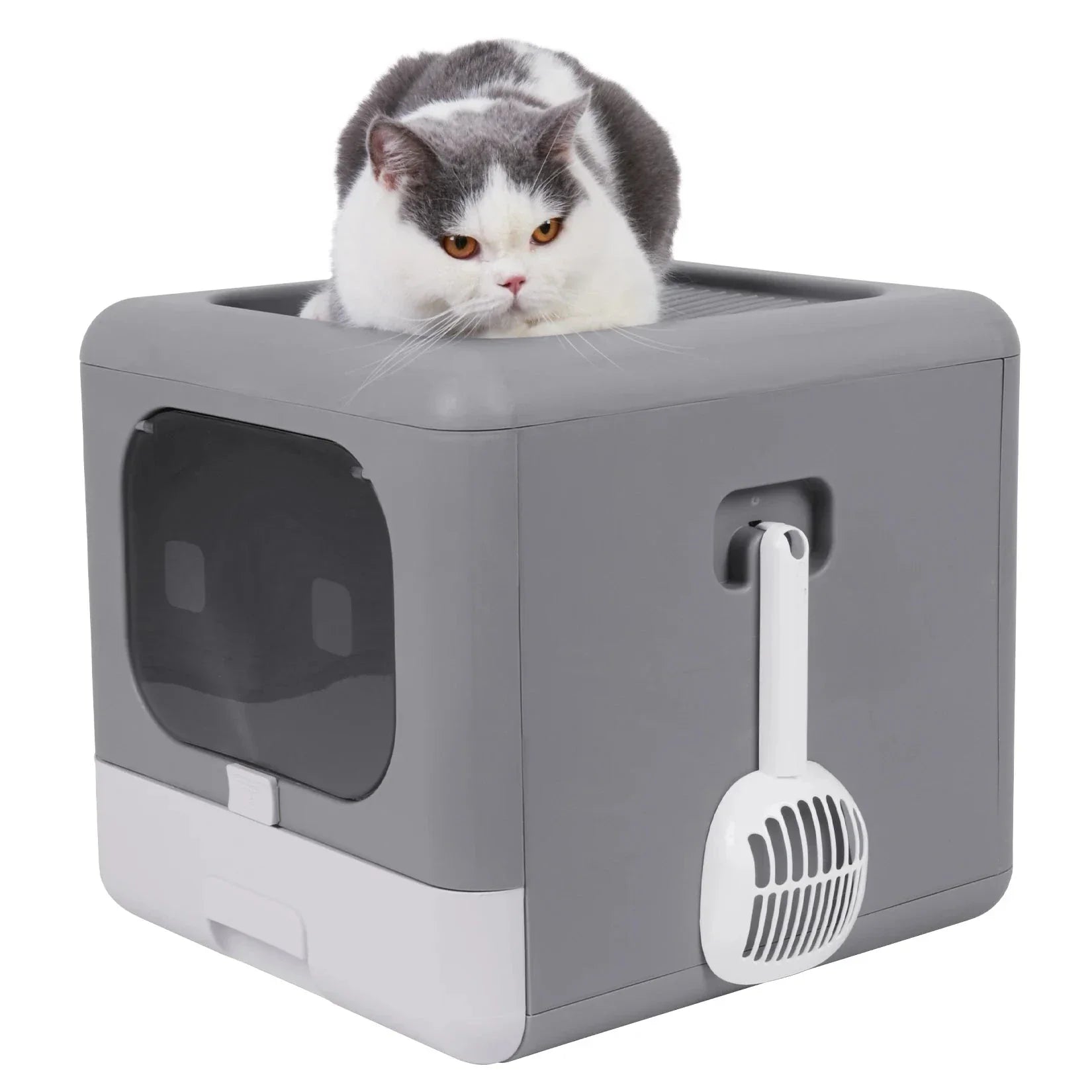 Gray and white cat resting on top of a modern gray covered litter box with a scoop attached