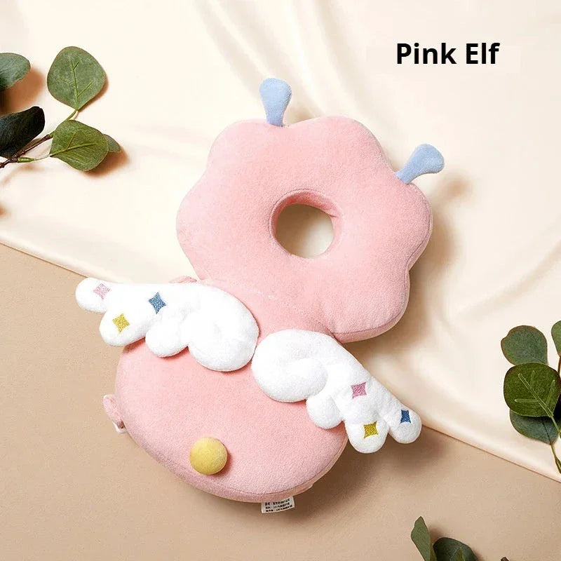 Pink elf-shaped plush pillow with wings and antennae on beige fabric background