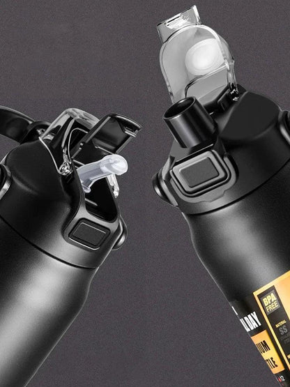 Close-up of black BPA-free sports water bottles with flip-top lids and push buttons on dark background