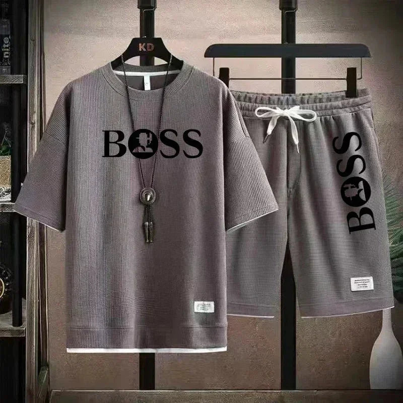 Grey casual two-piece outfit with BOSS logo, short-sleeve top and drawstring shorts on hangers