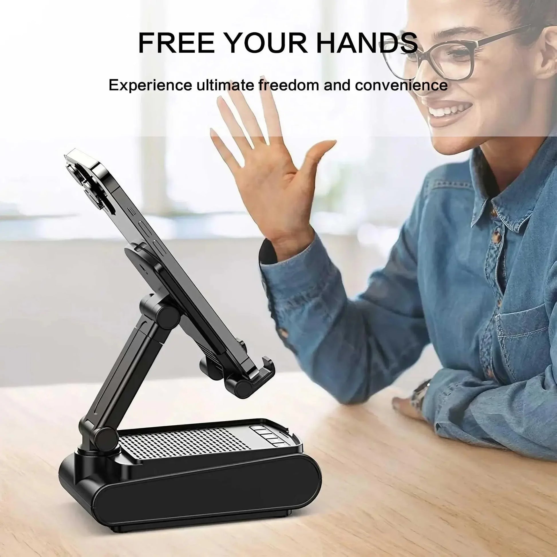 Woman with glasses waving at smartphone on adjustable black desk stand on wooden table