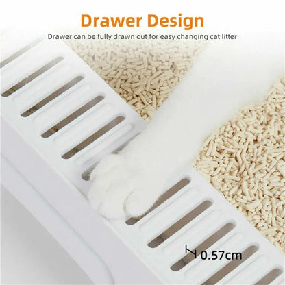 White cat paw stepping on a white plastic cat litter box drawer with wood pellet litter