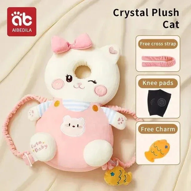 White cat-shaped plush baby head protector with pink bow and straps, includes knee pads and fish charm