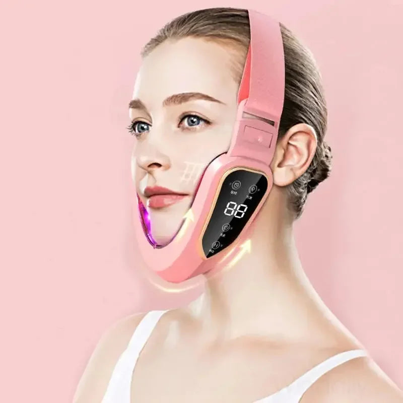 Woman wearing pink V-line face slimming massager with digital display on pink background