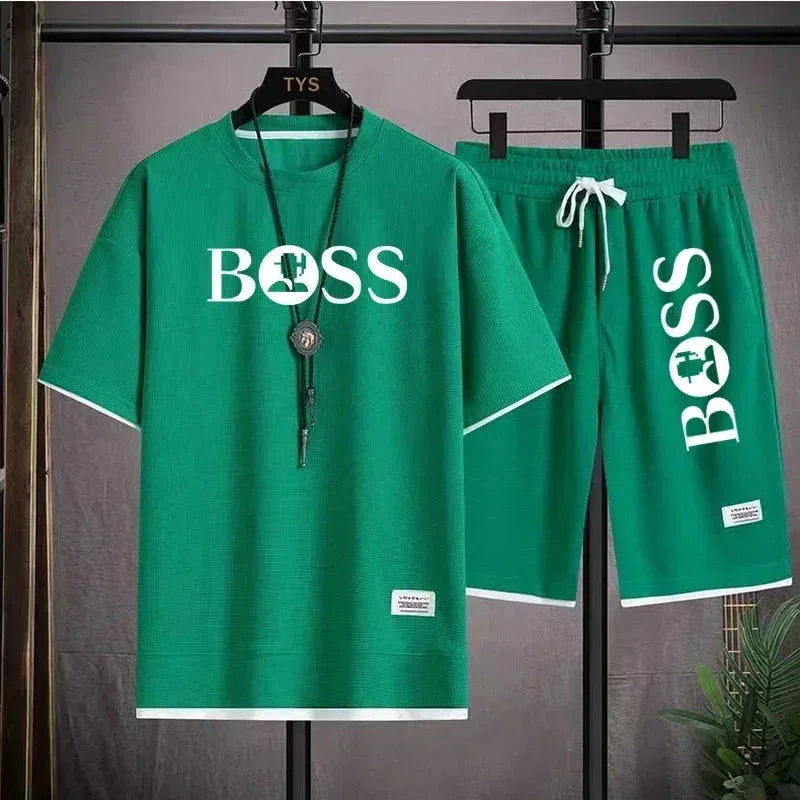 Green casual two-piece outfit with BOSS print, including short sleeve shirt and drawstring shorts